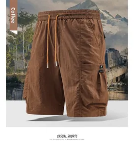 Detail view of coffee cargo shorts with elastic waistband, drawstring and large side pocket