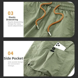Detail of green cargo shorts featuring elastic waistband with orange tipped drawstrings