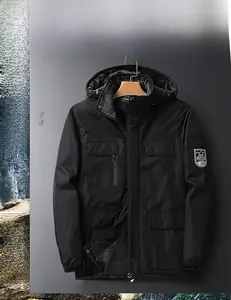 Detail of outdoor hooded jacket featuring fleece lining and geometric sleeve patch