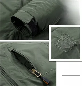 Detail of outdoor jacket showing velcro cuffs, shield embroidery and zipper pocket