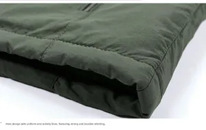 Detailed macro shot of army green winter jacket hem showing durable stitching and quilting