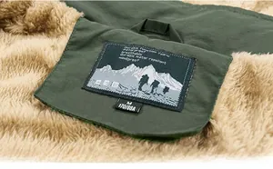 Detail of army green jacket featuring thick warm faux fleece lining and embroidered label