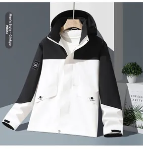 Detailed view of white and black mountain jacket sleeve with embroidered peak patch