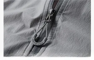 Detail of outdoor sun protection jacket featuring a durable metal zipper and easy-pull cord