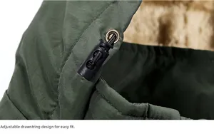 Detail of army green jacket showing metal eyelet, drawstring toggle, and warm fleece lining