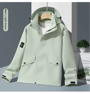 Detail of mint green hooded outdoor jacket with adjustable drawstrings and large flap pockets