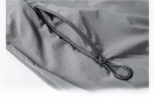 Close-up of functional zipper pocket on grey sun protection jacket with outdoor puller