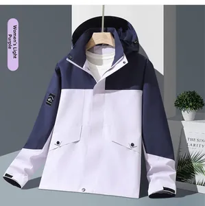 Detail of outdoor hooded jacket showing mountain sleeve patch and velcro cuffs