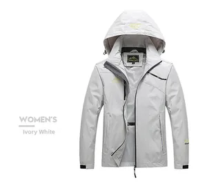 Detail of ivory white outdoor jacket featuring adjustable hood and mountain embroidery