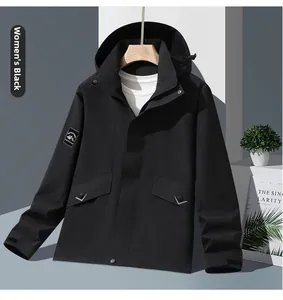 Detail of black hooded jacket with mountain patch, side pockets and windproof fabric