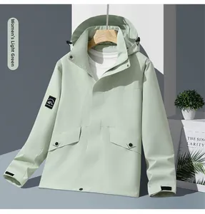 Detail of sage green hooded jacket featuring adjustable velcro cuffs and mountain arm patch