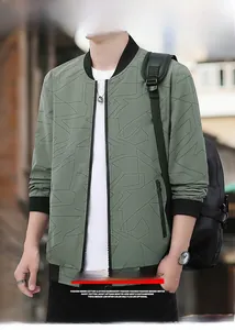 Detail of dark green baseball jacket showing geometric patterns and zipper pocket