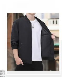 Detail of men's black bomber jacket featuring geometric texture and ribbed cuffs