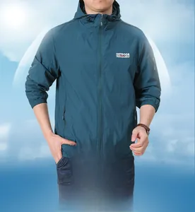 Detailed close-up of dark teal UV protection jacket with outdoor logo and sleeve pocket