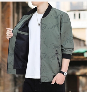 Detail of army green bomber jacket with map pattern texture and ribbed collar