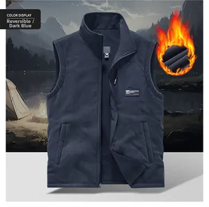 Detail of deep blue reversible fleece vest with zipper pockets and high stand collar