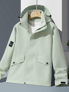 Mint green hooded outdoor waterproof windbreaker jacket with arm patch on hanger