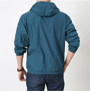 Detail of men's dark cyan sun protection jacket with hood and elasticated cuffs back view