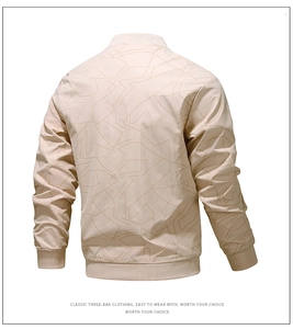 Rear view of a light beige bomber jacket featuring geometric line patterns and ribbed cuffs