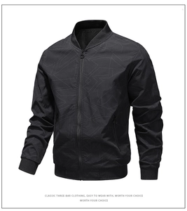 Detailed view of black bomber jacket with geometric pattern and ribbed baseball collar