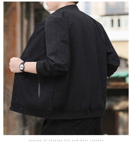 Détail de la veste business noire avec motif de feuilles discret et poignets côtelés