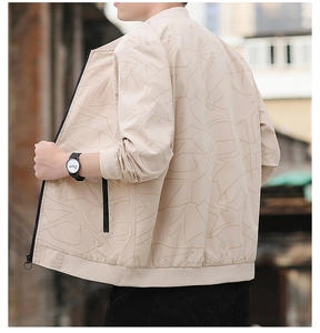 Detailed view of beige jacket with geometric line patterns and ribbed cuffs and hem