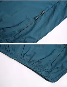 Detail of dark cyan sun protection jacket featuring sports zipper and elastic hem