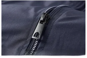 Close-up of durable black metal zipper and textured fabric on navy blue jacket