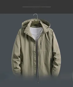 Detail view of military green hooded windbreaker with zip pockets and mesh lining
