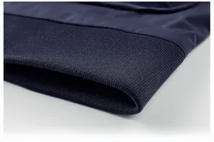 Detailed view of the navy blue ribbed hem showcasing its elasticity and knitting texture