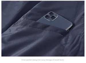 Detail of inner functional pocket on navy jacket showing smartphone storage capacity