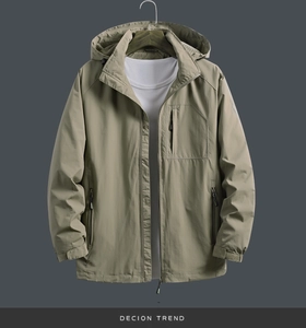 Detail of dark khaki windproof jacket featuring hooded design and zipper pockets
