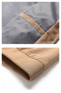 Detail of brown jacket with striped lining, interior pocket and elastic ribbed hem