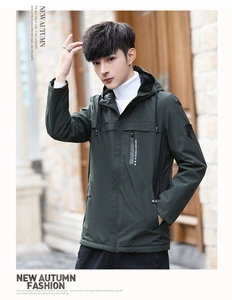 Detailed view of dark green hooded jacket featuring windproof zipper and chest pocket