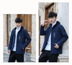Detail of navy blue hooded jacket with warm fleece lining and chest pocket embroidery