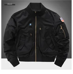Detail of black tactical bomber jacket featuring military patches and windproof nylon texture
