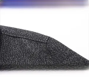 Detail of grey wool blend jacket showing textured fabric and structured shoulder seams