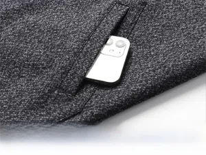 Detail view of deep gray tweed jacket side pocket with phone showing storage depth