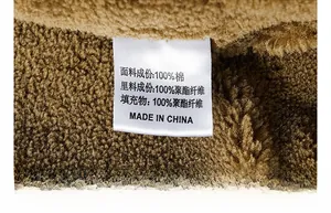 Detail of product label showing 100% cotton fabric and plush lining on a brown jacket