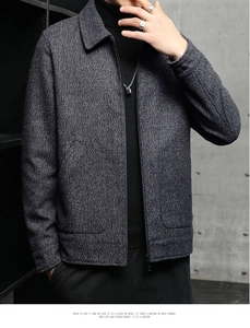 Detailed texture of charcoal grey wool blend business jacket with zipper and collar