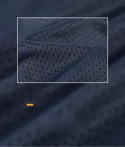 Close-up of navy blue breathable mesh fabric on windbreaker jacket showing texture