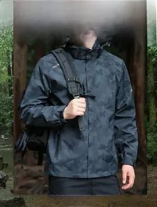 Detailed close-up of dark grey camo windbreaker jacket with detachable hood in outdoor forest