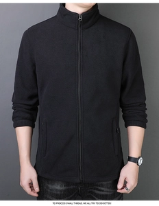 Detail view of black polar fleece jacket with high collar and sturdy metal zipper closure