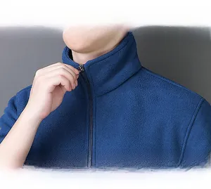 Detail view of the stand-up collar and zipper on a dark blue men fleece warm jacket