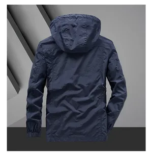 Back view of navy blue hooded windbreaker jacket with ripstop texture and elastic cuffs
