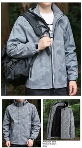 Detail of grey camo windbreaker jacket with hooded design and grid texture for hiking