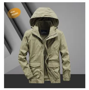 Close-up of khaki outdoor jacket showing breathable mesh lining and tactical pocket details