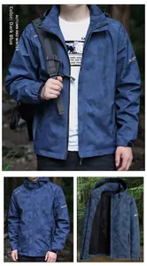 Detail of men's hooded outdoor jacket in dark blue camouflage with zipper pockets