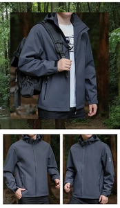 Detailed close-up of dark grey functional jacket with velcro cuffs and hood in forest