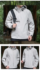 Detail view of light grey outdoor windbreaker with zipper pockets and adjustable cuffs
